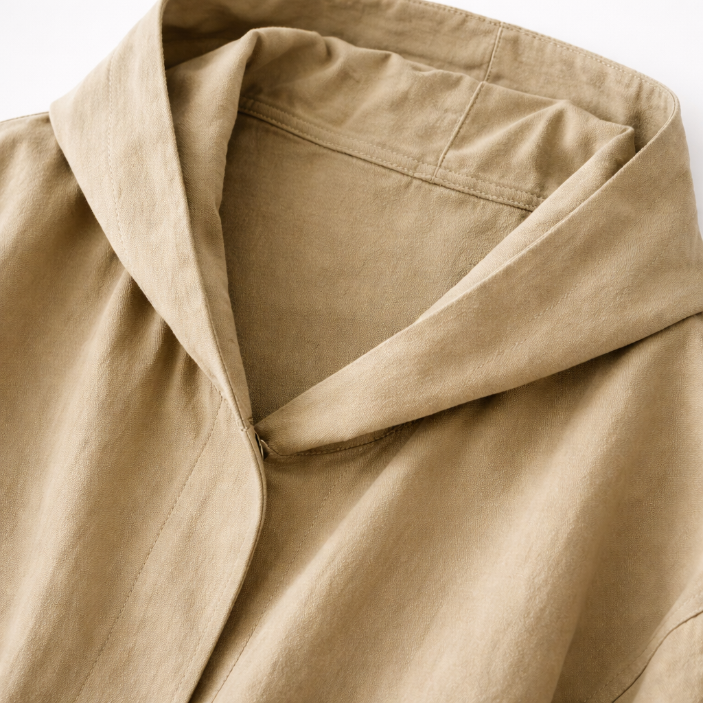 Abrigo largo con capucha y silueta oversized fluida con bolsillos amplios